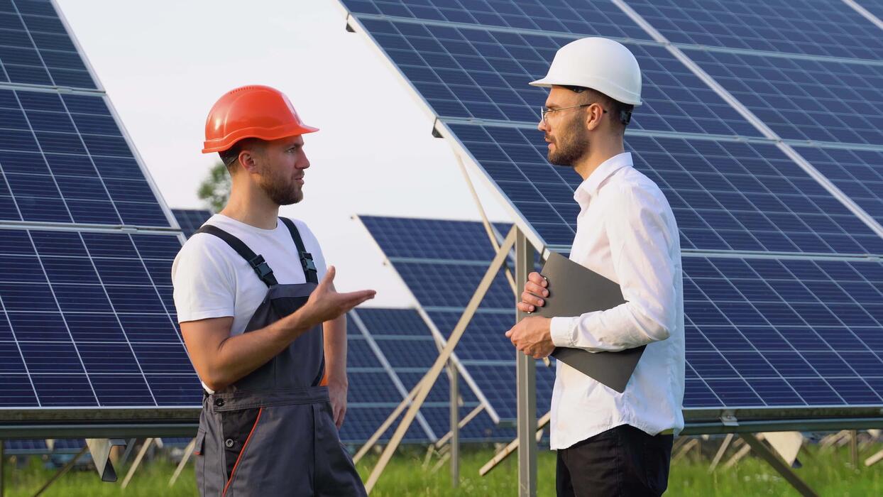 two people having a shaking hands against solar panel after the conclusion of the agreement in the renewable energy video